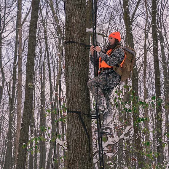 Allie climbing a tree to get a better perspective for the hunt.