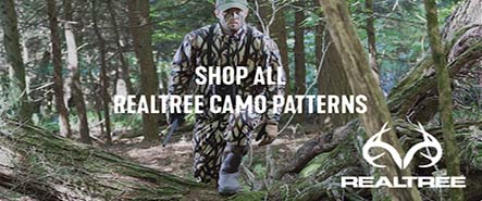 Hunter walking through woods with Realtree camo