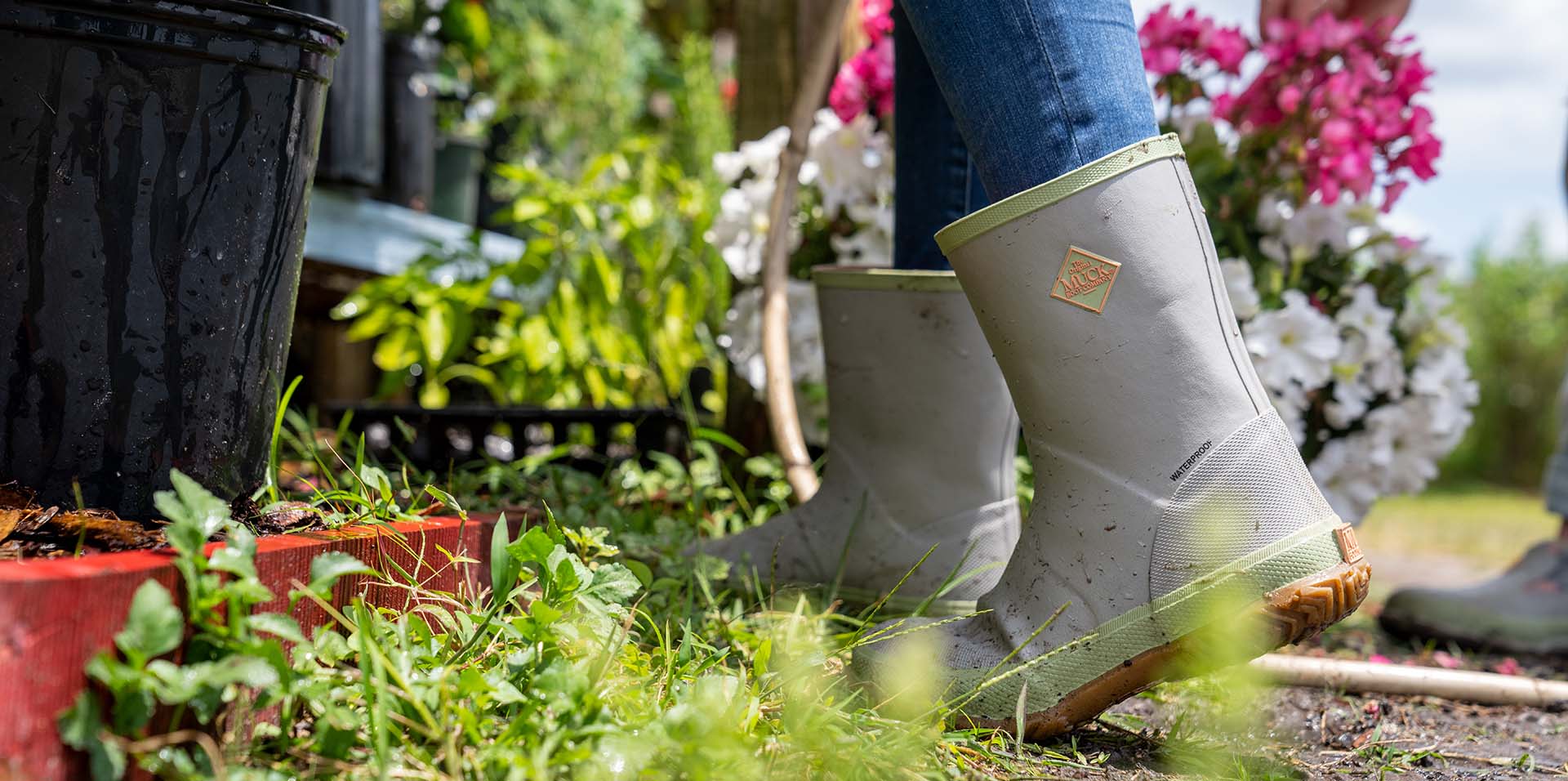 person wearing xtratuf ankle deck boots near a fire