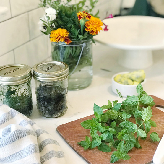 Flowers and herbs sitting on a counter