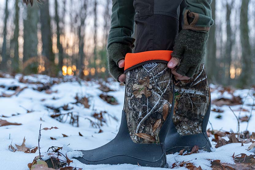 Allie adjusting her Muck boot as they keep her feet warm in the cold winter