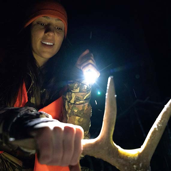 Allie checking out the antlers on her hunt trophy.