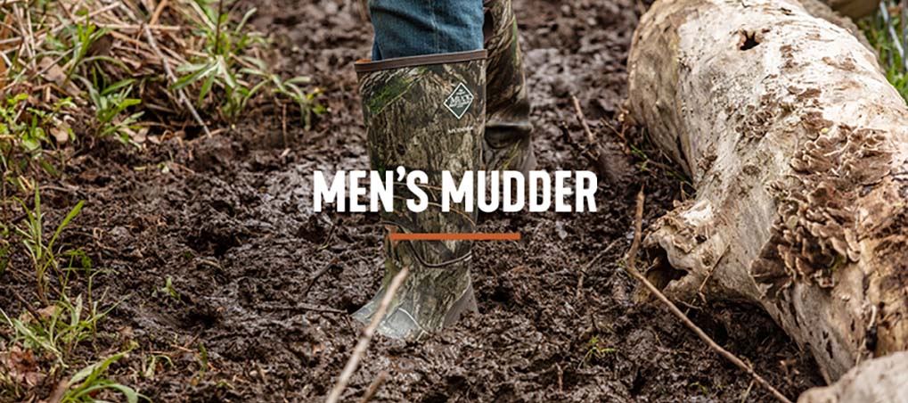 'Men's Mudder' Man walking through ankle deep mud wearing his Muck Mudder boots